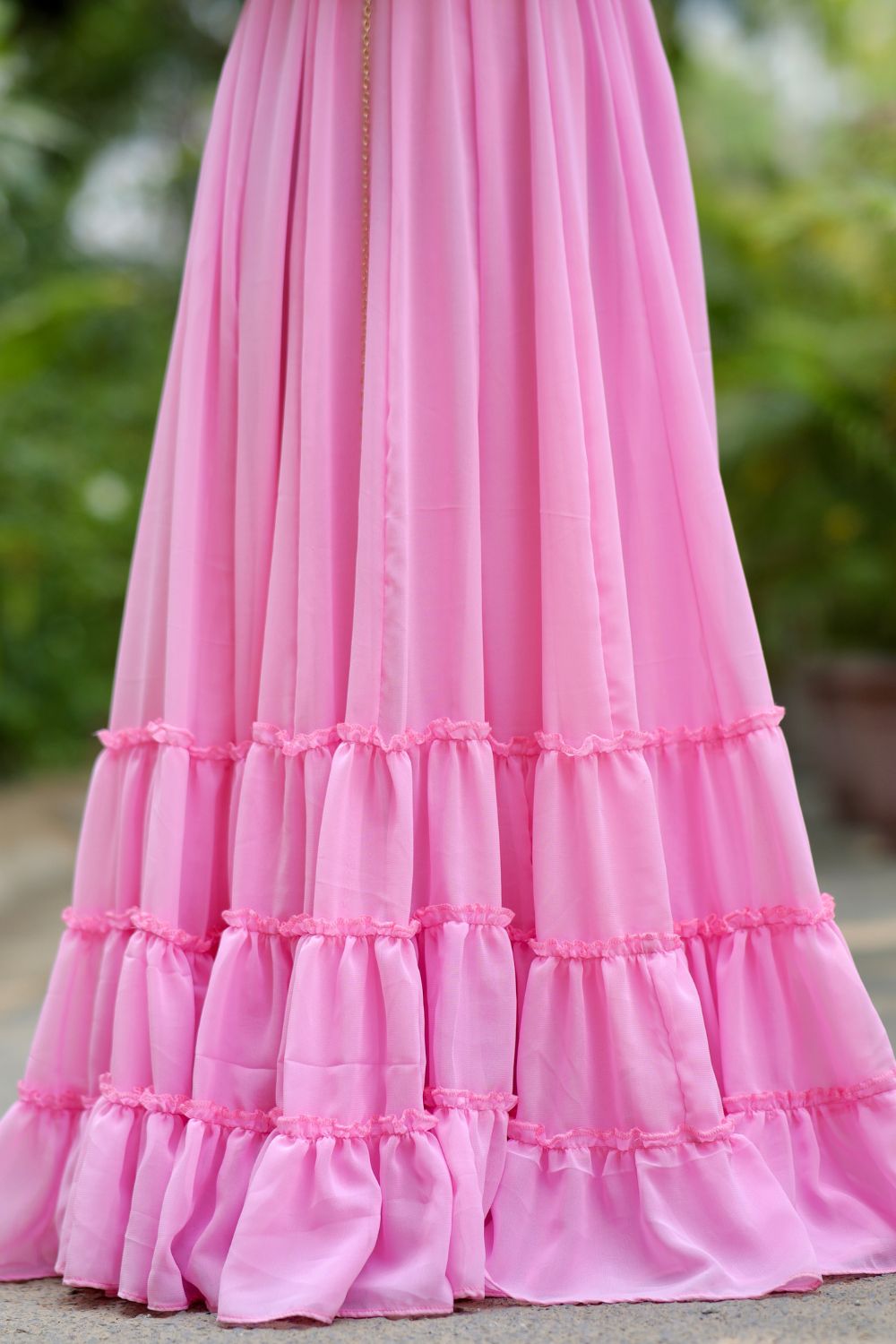 Pink Diya Gown by Imagine By Shiwali, featuring intricate embroidery and flowing fabric, displayed on a hanger.