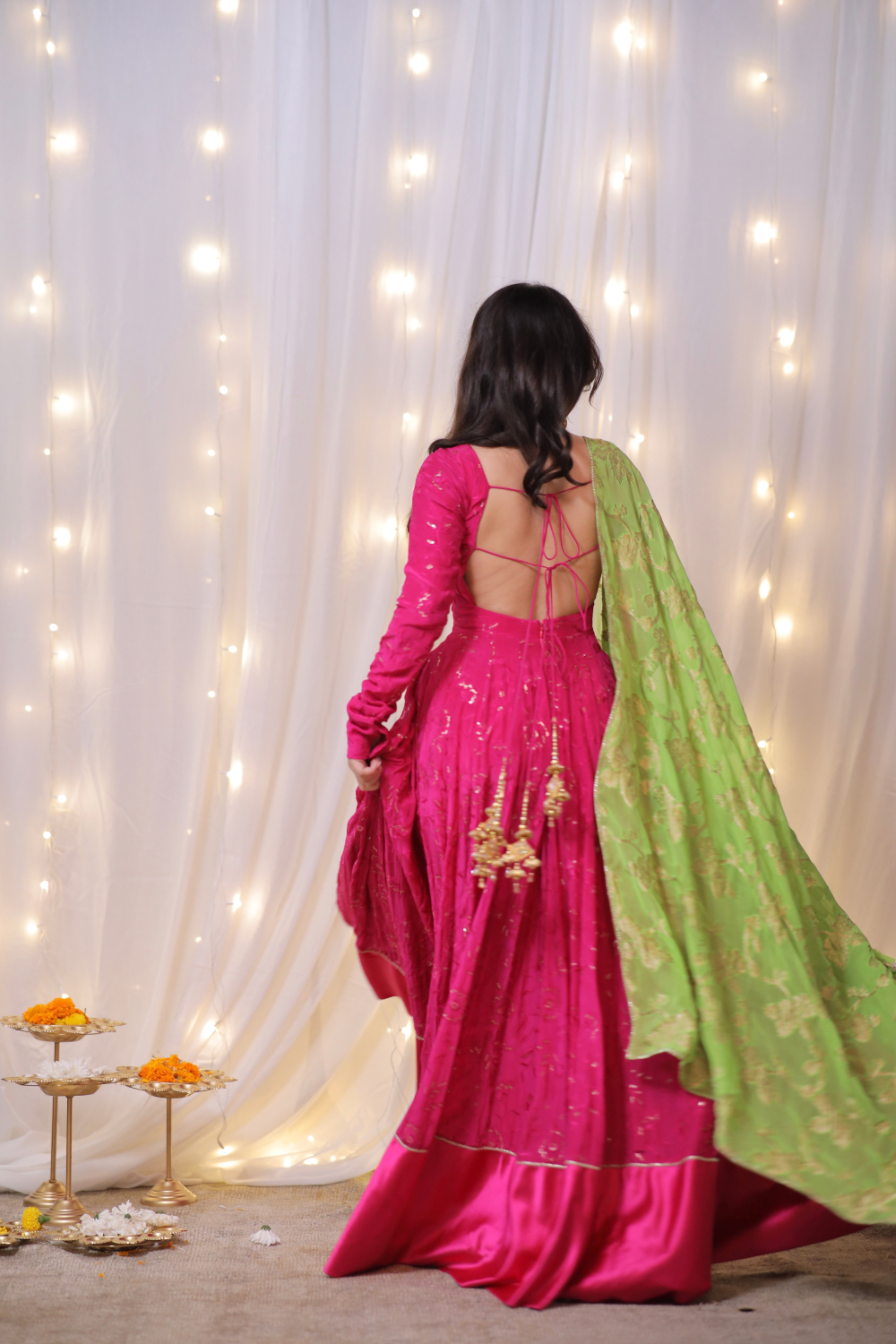 Fuchsia pink Sanvi Lehenga with embroidery, green dupatta, and matching potli bag from Imagine By Shiwali.