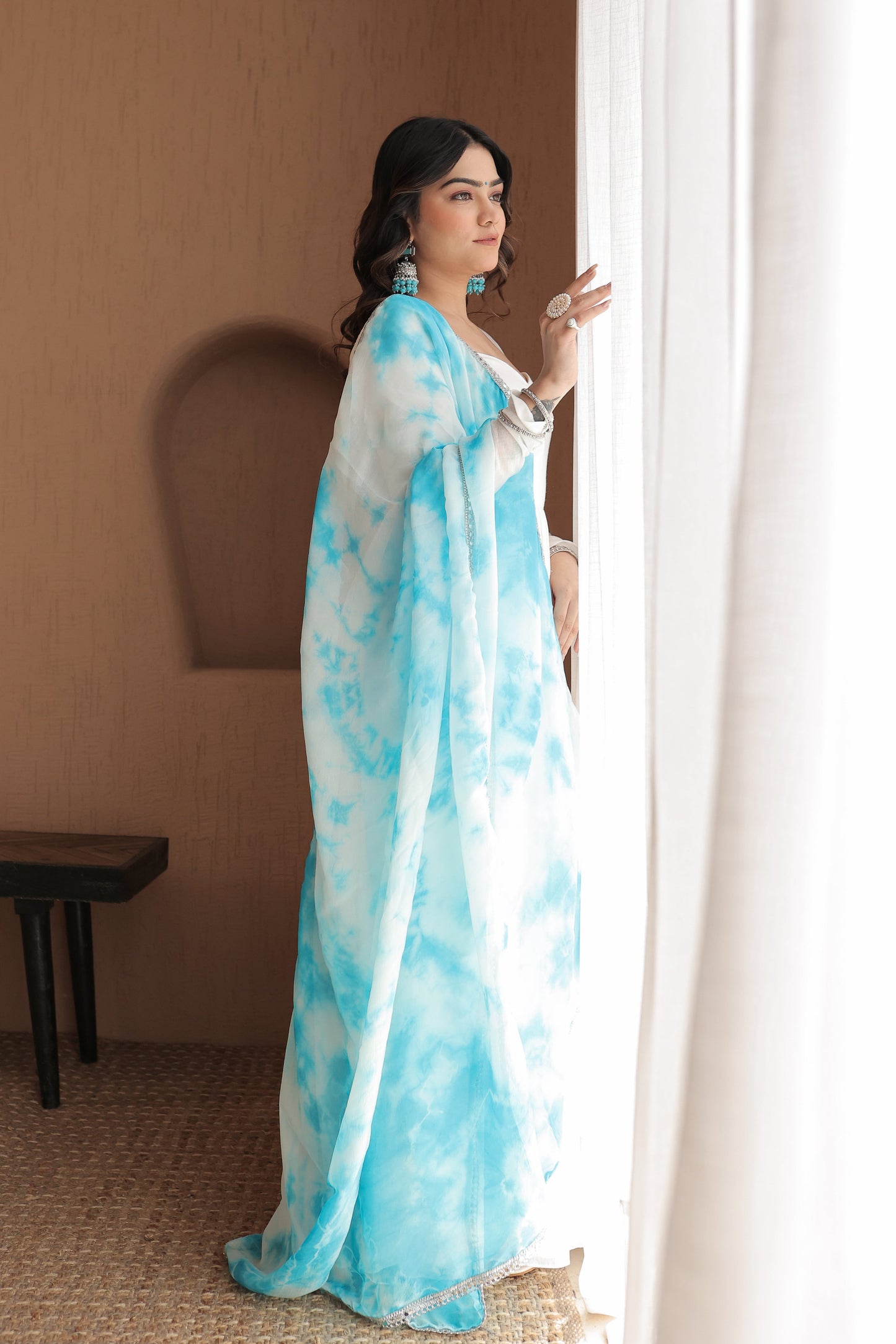 Chandani white mulmul Anarkali dress by Imagine By Shiwali with intricate embroidery and flowing fabric.
