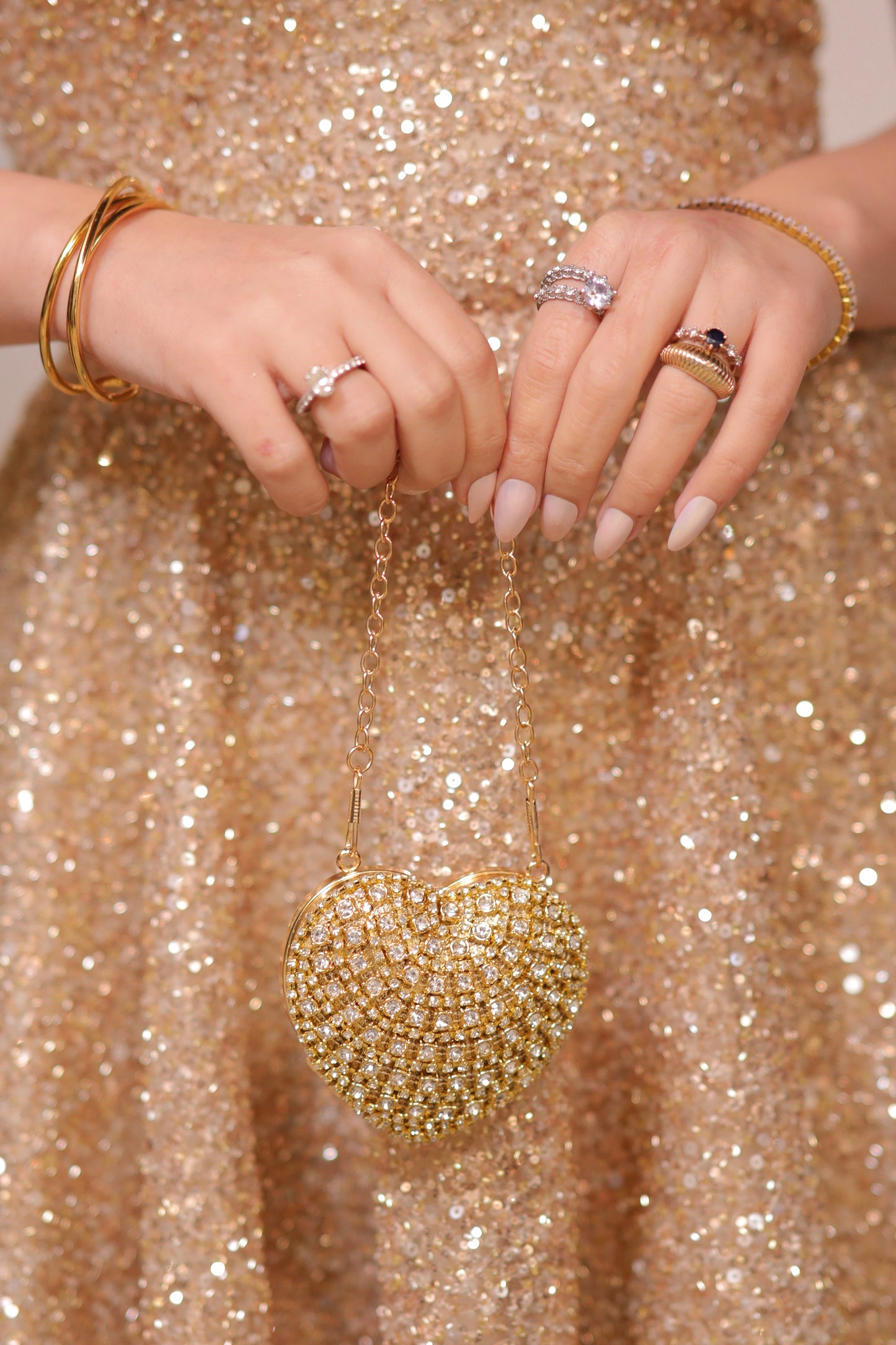 Sam Heart Bag by Imagine By Shiwali in golden color, featuring a heart-shaped design with a sleek, stylish appearance.