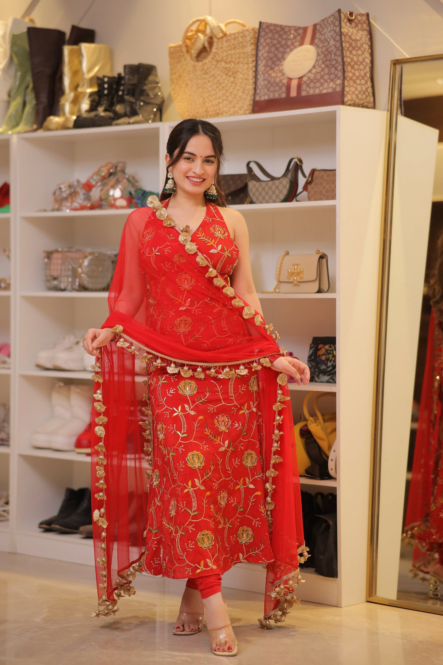 Red Manirika suit by Imagine By Shiwali featuring traditional embroidery and a fitted silhouette, shown in a close-up shot.