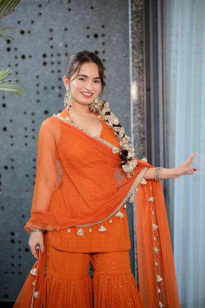 Rust Sharara suit from Imagine By Shiwali featuring intricate embroidery and a matching kurta with flared pants.