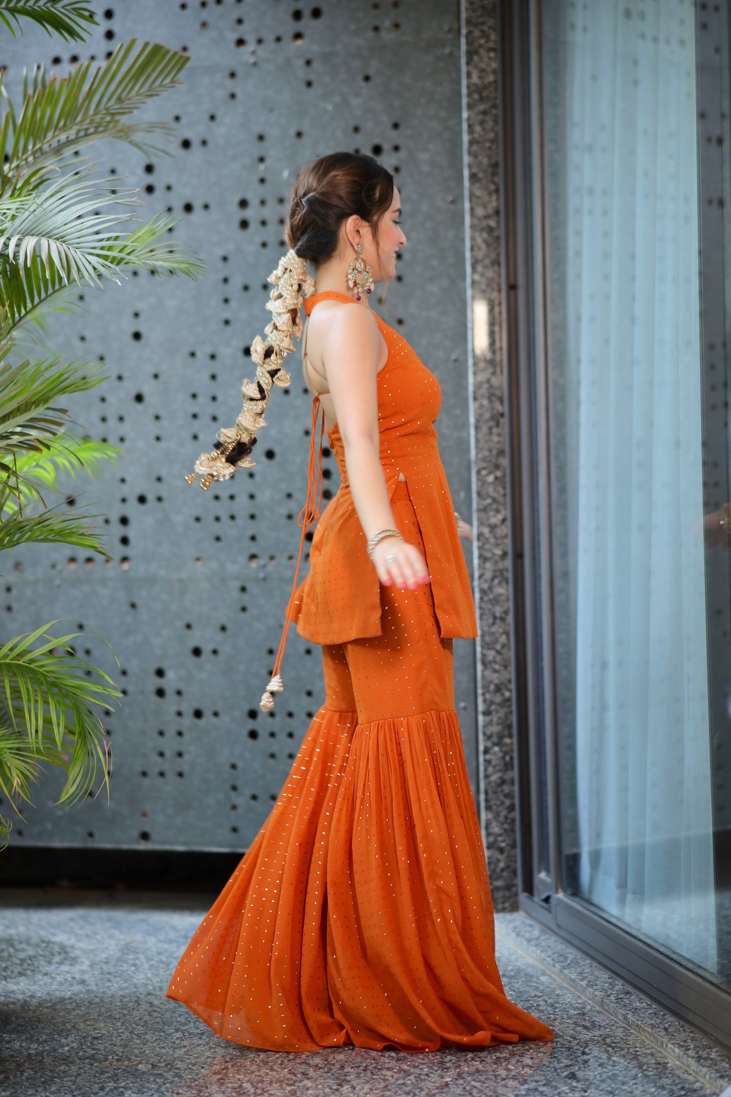 Rust-colored Ananya Sharara suit by Imagine By Shiwali, featuring intricate embroidery and a flowing sharara bottom.