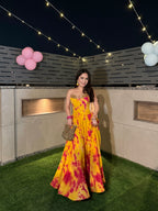 Yellow and pink tie-dye Sia corset lehenga by Imagine By Shiwali, featuring intricate embroidery and traditional design details.