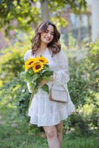 White Vanessa frill dress by Imagine By Shiwali, featuring ruffled details and a flowy silhouette, displayed on a model.