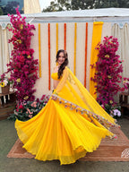 Yellow mirror-embellished lehenga with intricate embroidery, featuring vibrant sunshine yellow fabric and traditional design details.