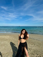 Scarlet black bikini set by Imagine By Shiwali with triangle top and matching bottoms, displayed on a flat surface.