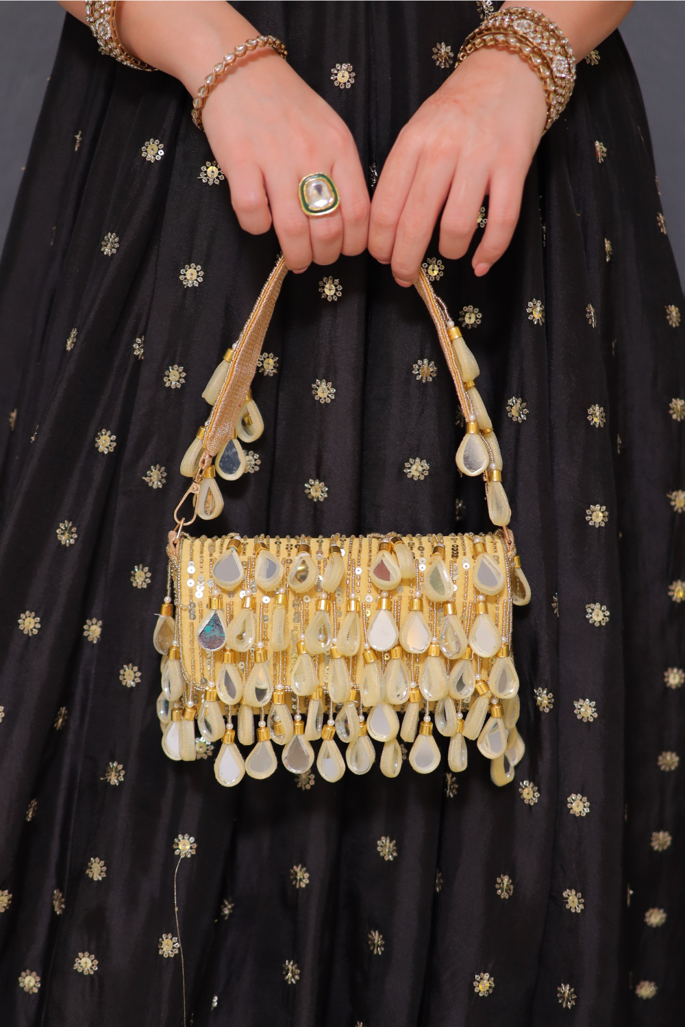 Rani golden mirrorwork bag by Imagine By Shiwali featuring intricate mirror embroidery and traditional design.