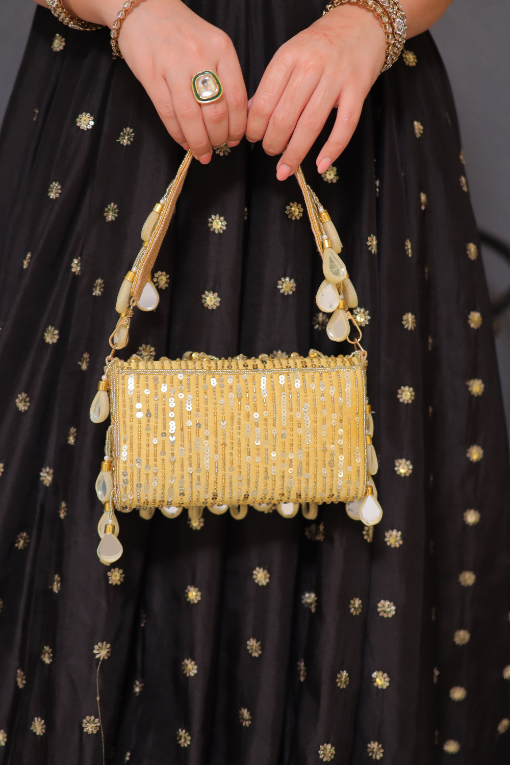 Rani golden mirrorwork bag by Imagine By Shiwali featuring intricate mirror embroidery and traditional design.