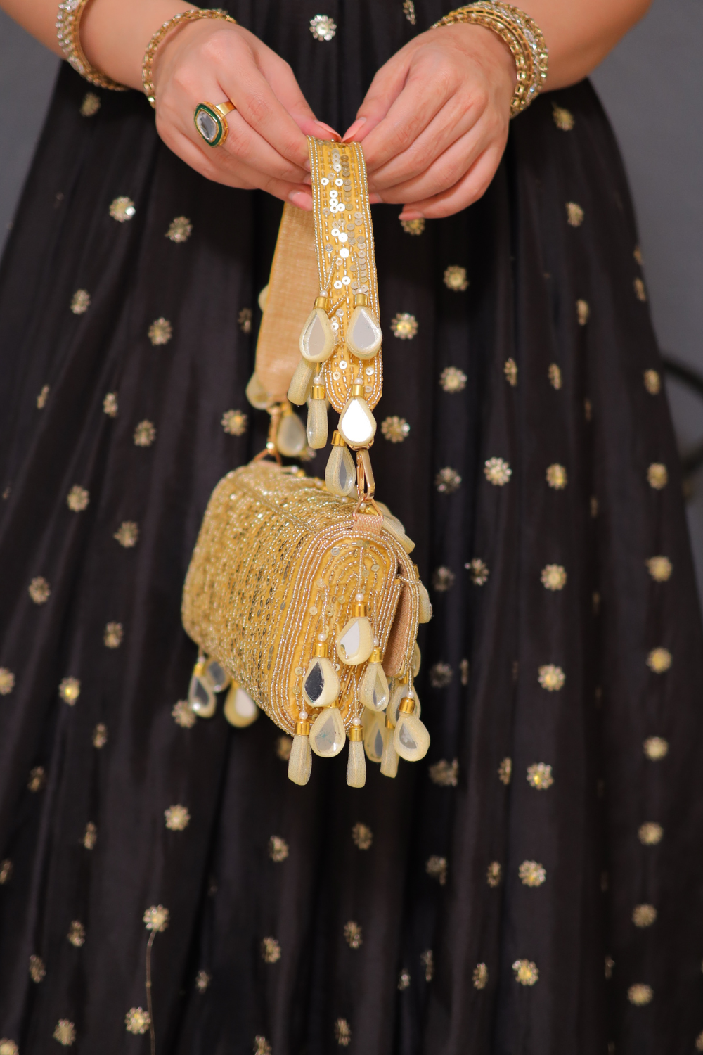 Rani golden mirrorwork bag by Imagine By Shiwali featuring intricate mirror embellishments and traditional embroidery.
