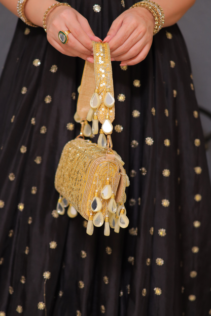 Rani golden mirrorwork bag by Imagine By Shiwali featuring intricate mirror embellishments and traditional embroidery.