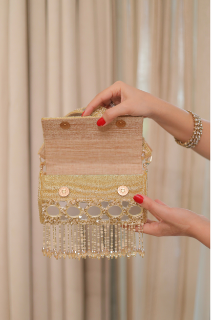 Imagine by Shiwali Rimjim mirror bag showing its compact design with a mirror and stylish handle in natural light.