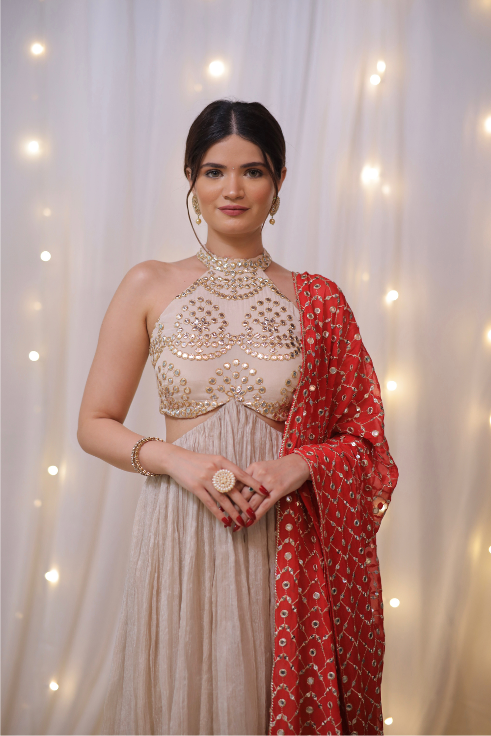 Champagne gold halter Anarkali set with mirror embellishments by Imagine By Shiwali, featuring intricate embroidery and a flowing silhouette.