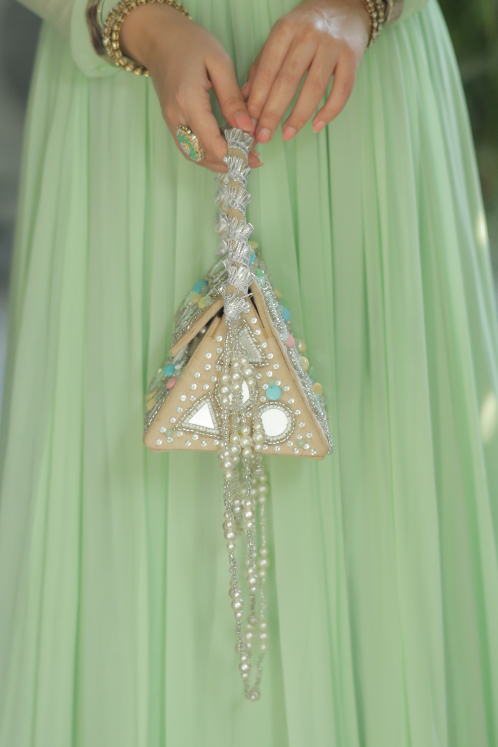 White Roma watergold color bag with intricate mirrorwork design by Imagine By Shiwali.