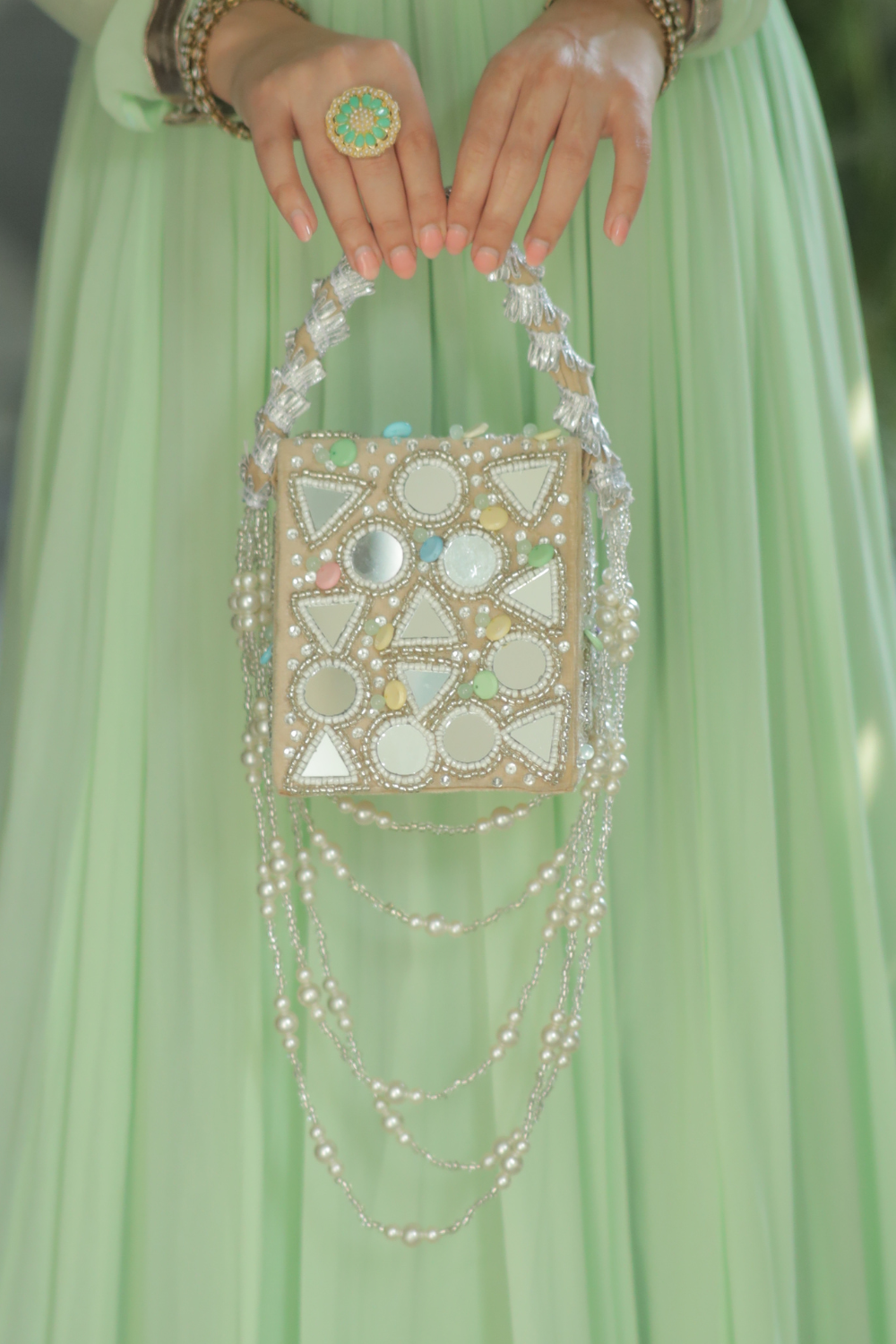 Roma watergold color mirrorwork bag by Imagine By Shiwali featuring intricate mirror embellishments and elegant design.