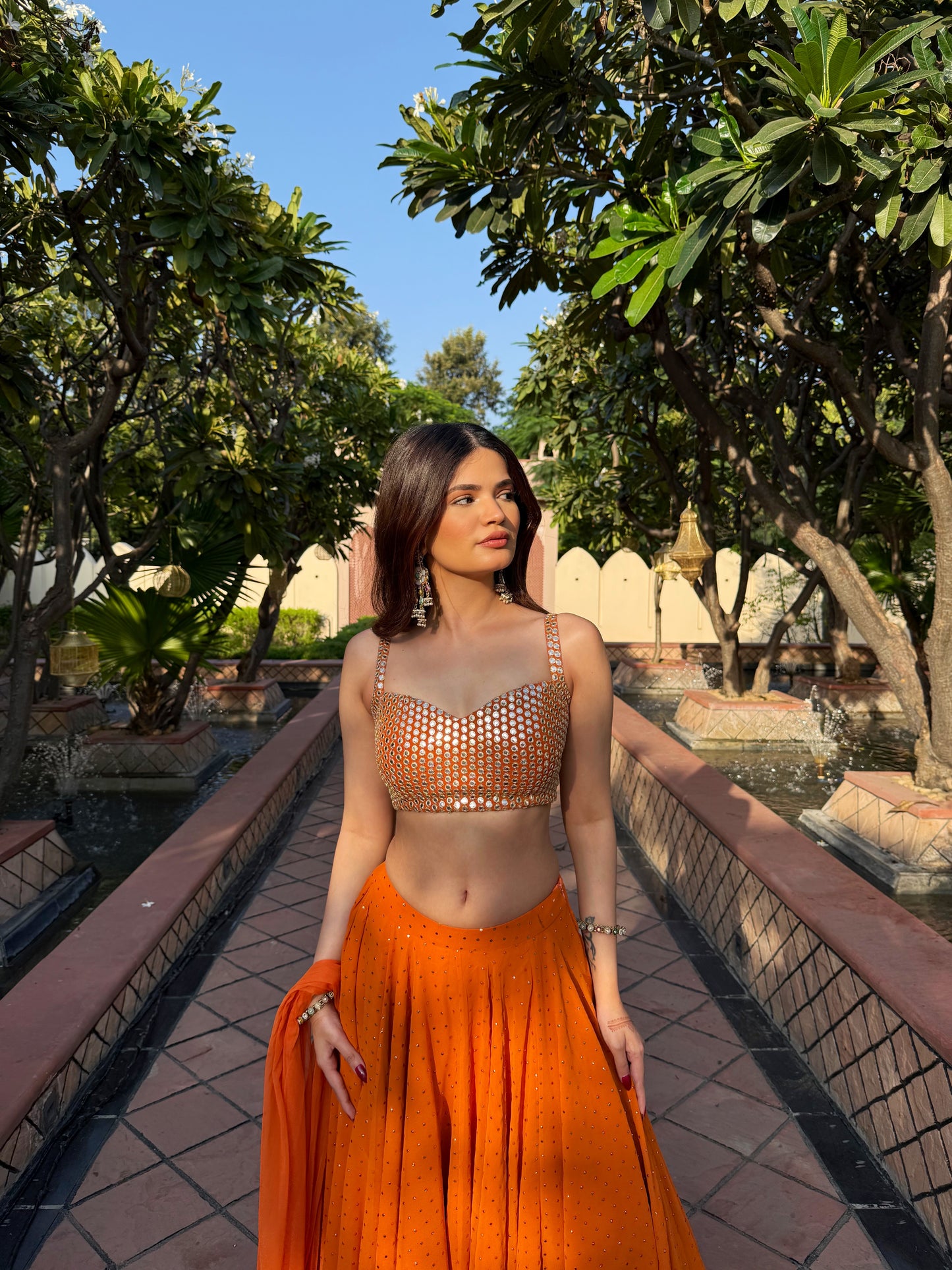 Orange Chameli Lehenga by Imagine By Shiwali featuring intricate embroidery and a flowing silhouette.