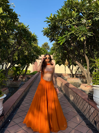 Bright orange Chameli Lehnga by Imagine By Shiwali featuring intricate embroidery and traditional design.