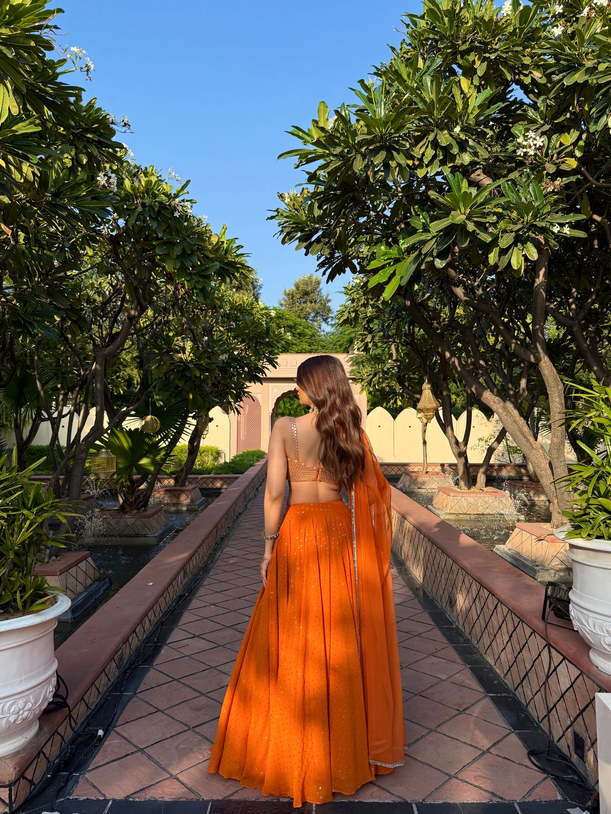 Orange Chameli Lehnga by Imagine By Shiwali featuring intricate embroidery and traditional design.