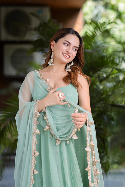 Mint green Dolly Anarkali dress by Imagine By Shiwali featuring intricate embroidery and flowing fabric.