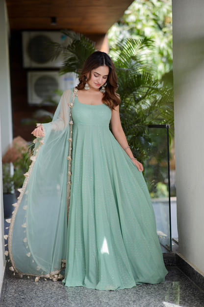 Mint green Dolly Anarkali dress by Imagine Shiwali with intricate embroidery and flowing fabric, showcased on a model.