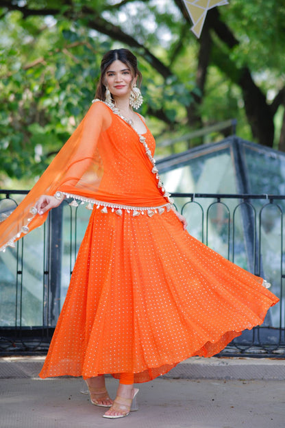 Dolly Orange Anarkali Suit by Imagine By Shiwali featuring intricate embroidery and flowing fabric, traditional Indian attire.