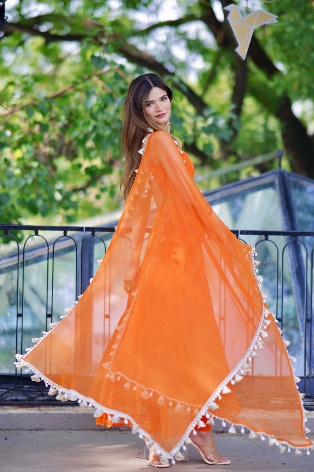 Dolly Orange Anarkali Suit by Imagine By Shiwali, featuring intricate embroidery and flowing fabric, displayed on a mannequin.