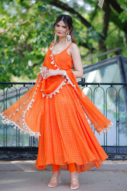 Dolly Orange Anarkali Suit by Imagine By Shiwali featuring intricate embroidery and flowing fabric in vibrant orange.