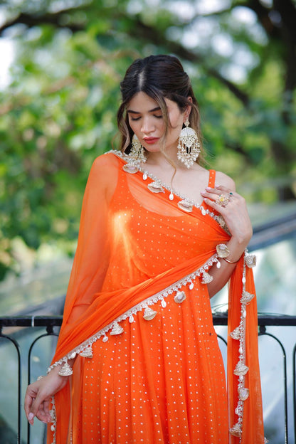 Dolly Orange Anarkali Suit by Imagine By Shiwali featuring intricate embroidery and flowing fabric, designed for festive occasions.