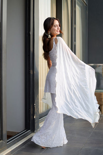 White Laila Chikankari Sharara Suit by Imagine By Shiwali, featuring intricate embroidery and traditional design.