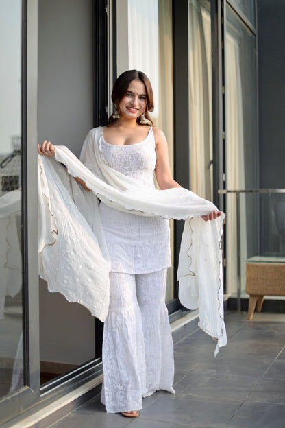 White Laila Chikankari Sharara suit by Imagine By Shiwali, featuring intricate embroidery and traditional design, shown on a model.