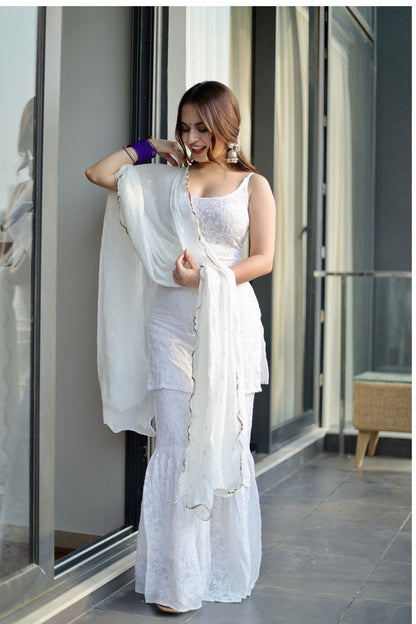 White Laila Chikankari Sharara suit by Imagine By Shiwali, featuring intricate embroidery and traditional design.