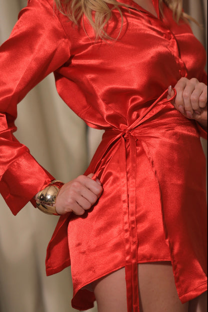 Red satin shirt dress with wrap skirt by Imagine By Shiwali, featuring a stylish collar and button-up front.
