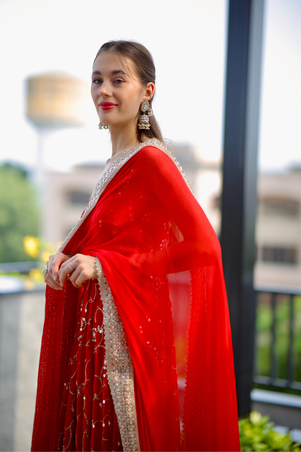 Red Maastani Anarkali suit by Imagine By Shiwali featuring intricate embroidery and flowing fabric.