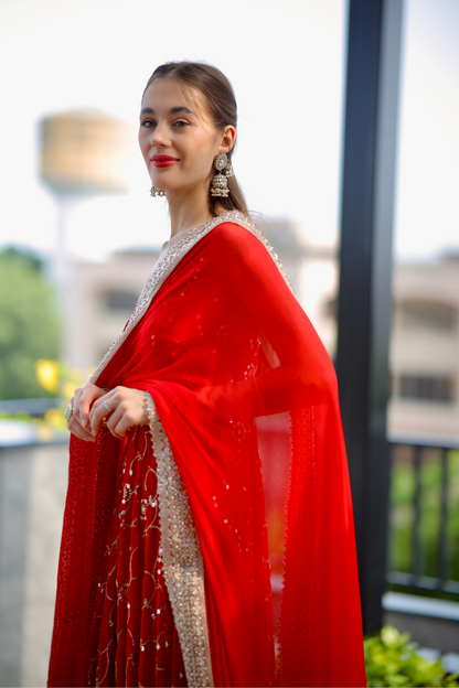 Red Maastani Anarkali suit by Imagine By Shiwali featuring intricate embroidery and flowing fabric.