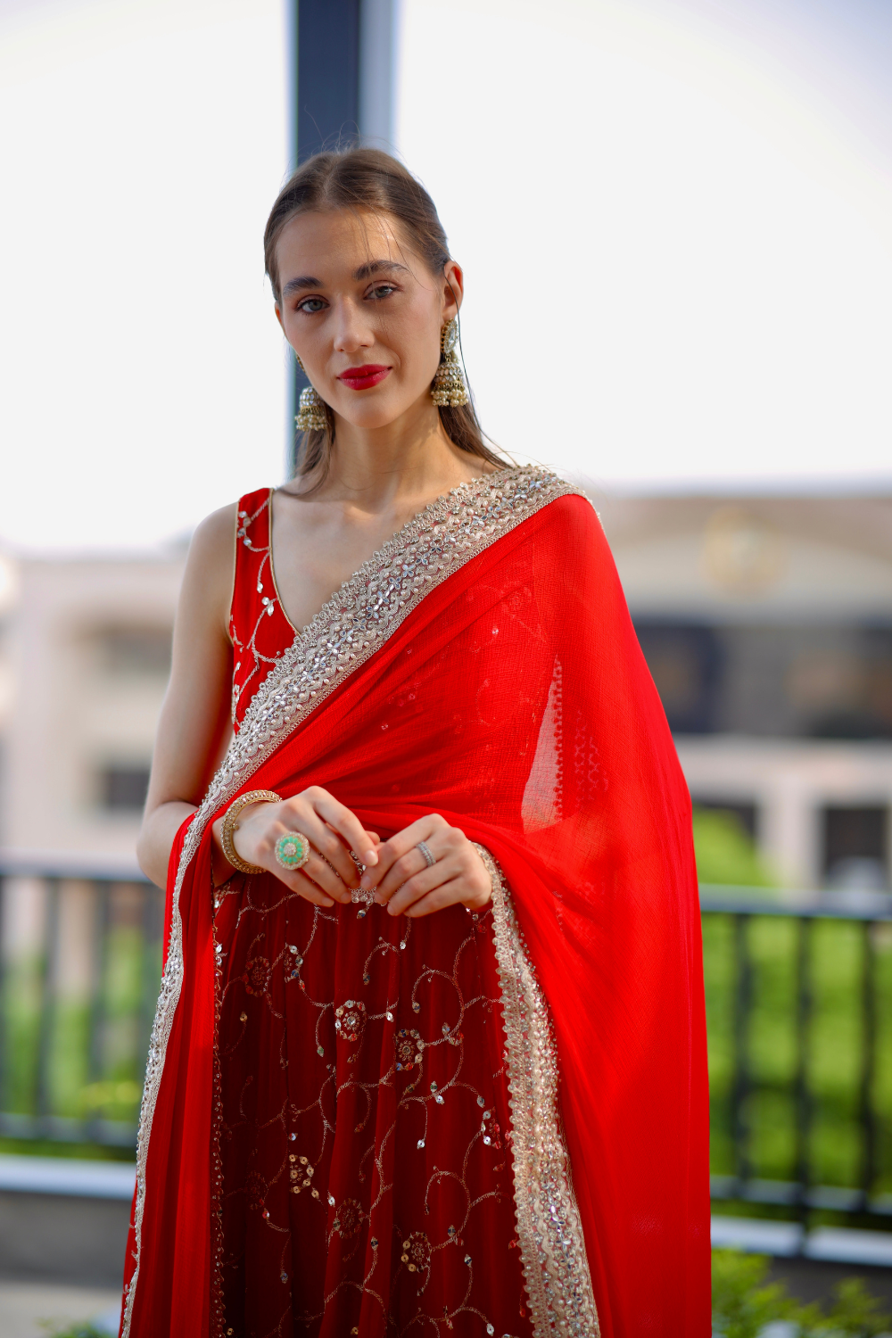 Red Maastani Anarkali dress by Imagine By Shiwali featuring intricate embroidery and flowing fabric, displayed on a hanger.
