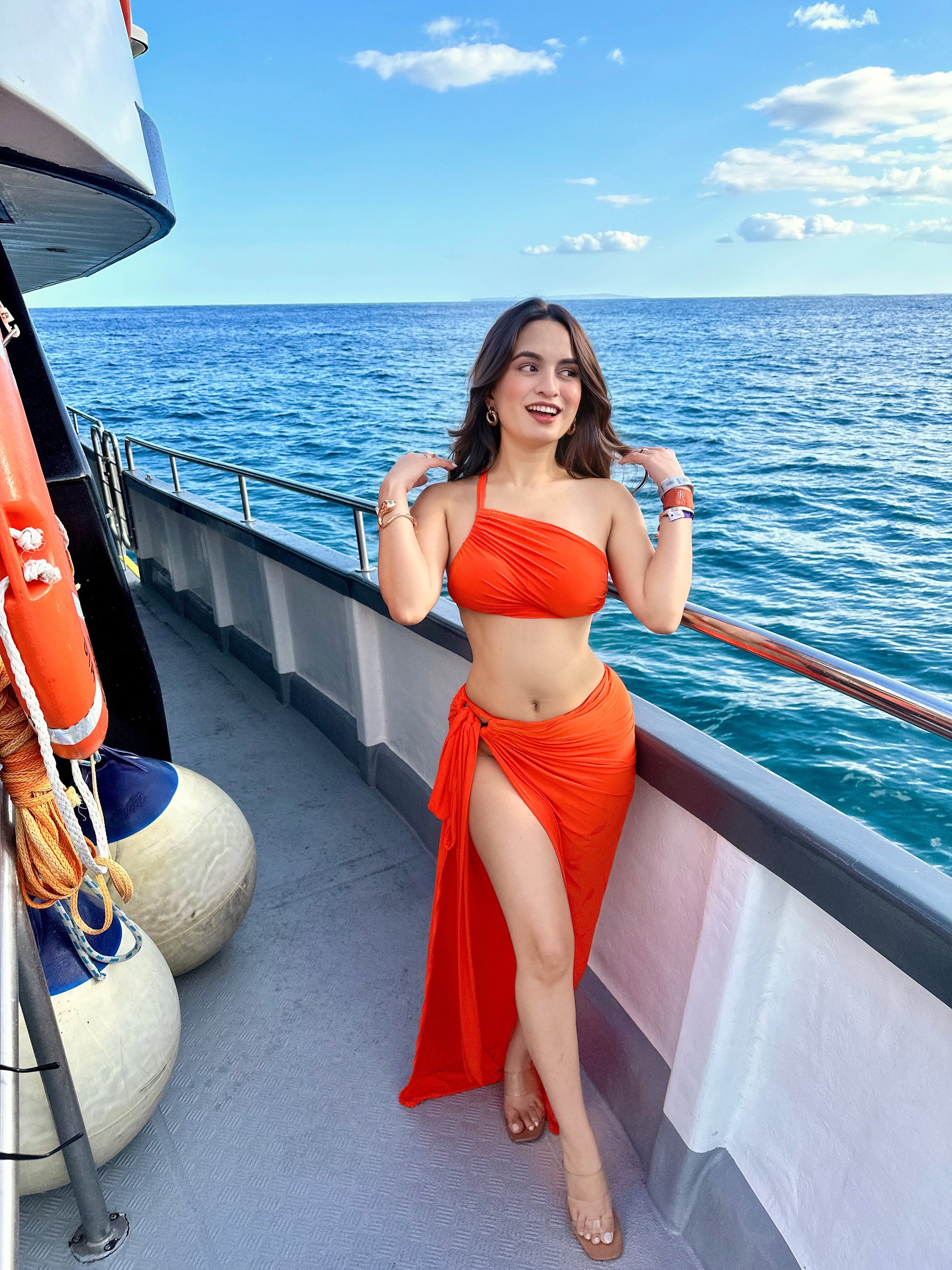 Orange Marbella ruched tank top and slit skirt set by Imagine By Shiwali, featuring a fitted top and flowy skirt.