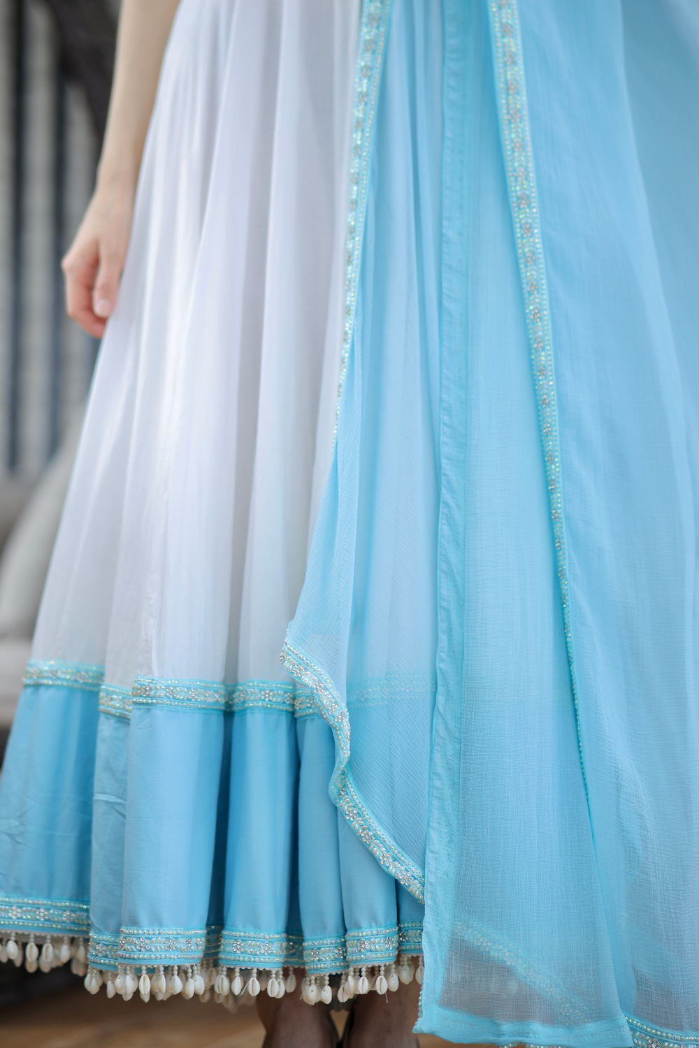 White and blue Meera Anarkali dress by Imagine By Shiwali featuring intricate embroidery and flowing fabric.