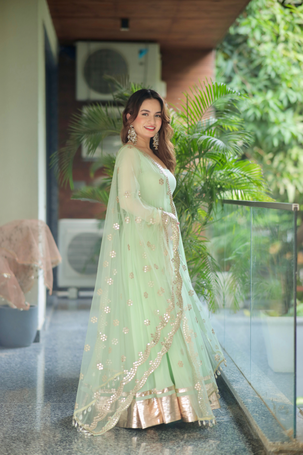 Imagine By Shiwali Morni green anarkali with intricate embroidery and flowy fabric, displayed on a hanger.