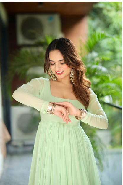 Green Morni Anarkali dress by Imagine By Shiwali featuring intricate embroidery and flowing fabric, displayed on a mannequin.