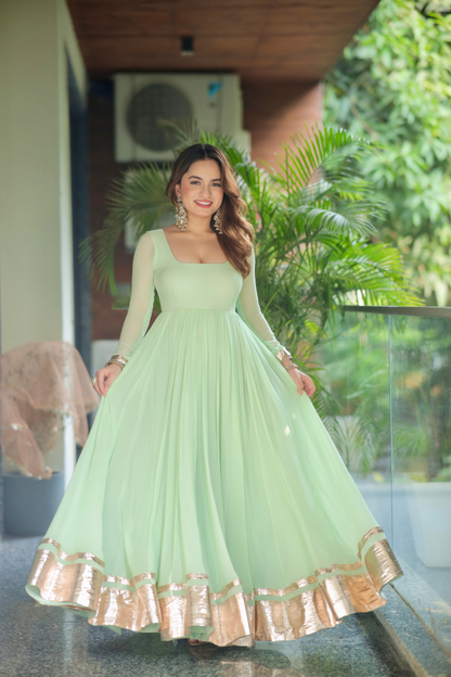 Green Morni Anarkali dress by Imagine By Shiwali with intricate embroidery and flowing fabric, displayed on a mannequin.