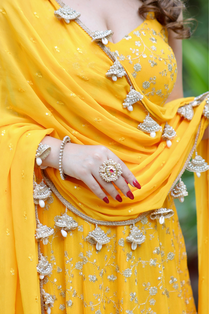 Yellow Noor Anarkali dress with intricate Zari work by Imagine By Shiwali, featuring detailed embroidery and traditional design.
