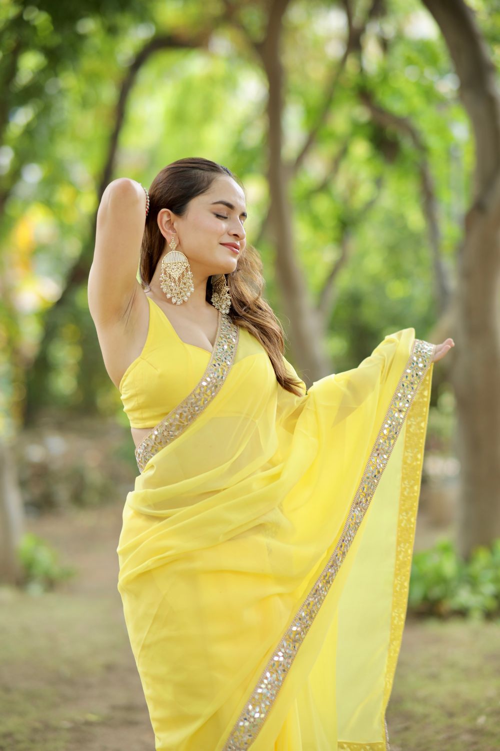Yellow Raveena Georgette saree with matching blouse from Imagine By Shiwali, featuring elegant drape and intricate design details.