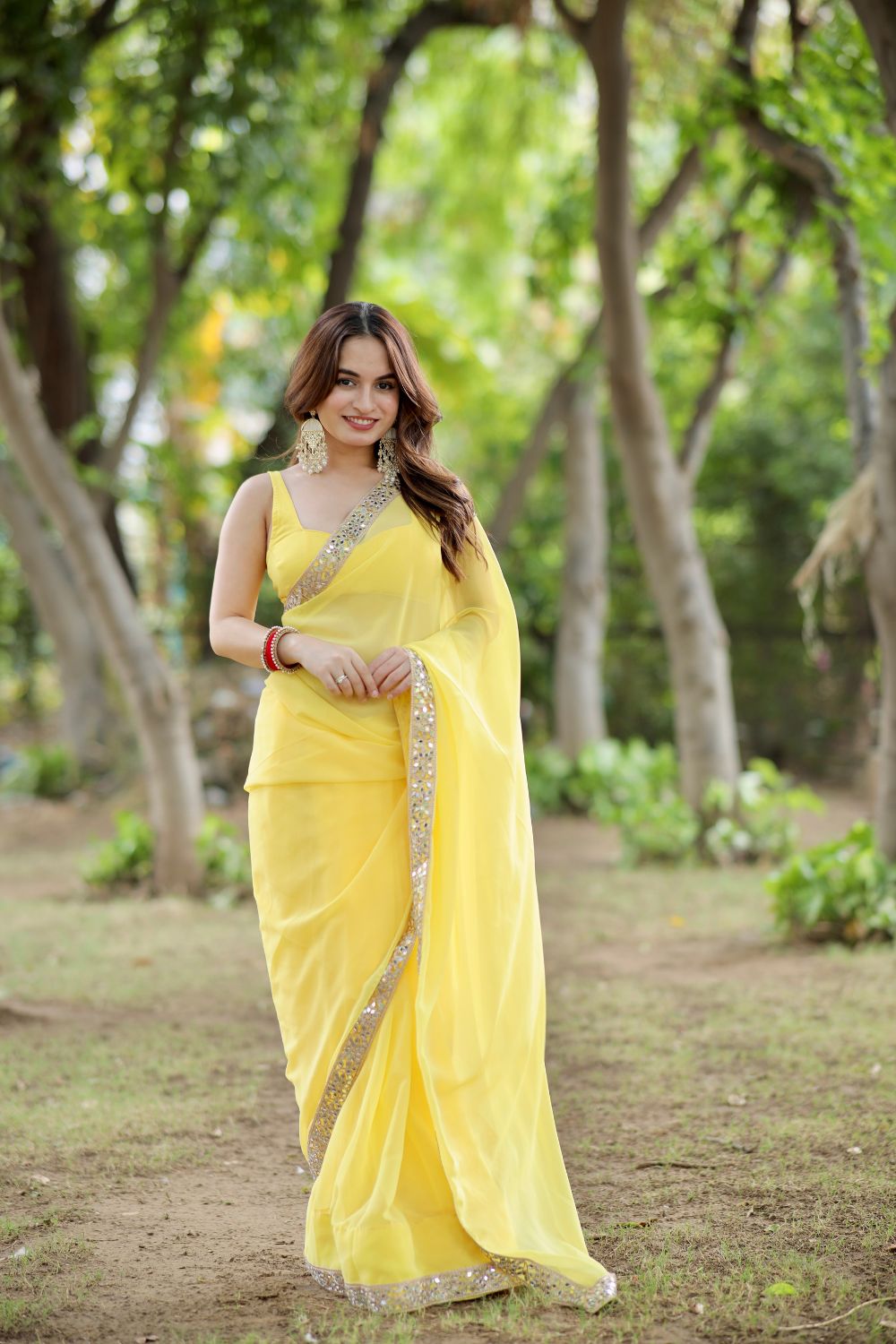 Yellow Raveena Georgette saree with matching blouse from Imagine By Shiwali, showcasing intricate drape and vibrant color.