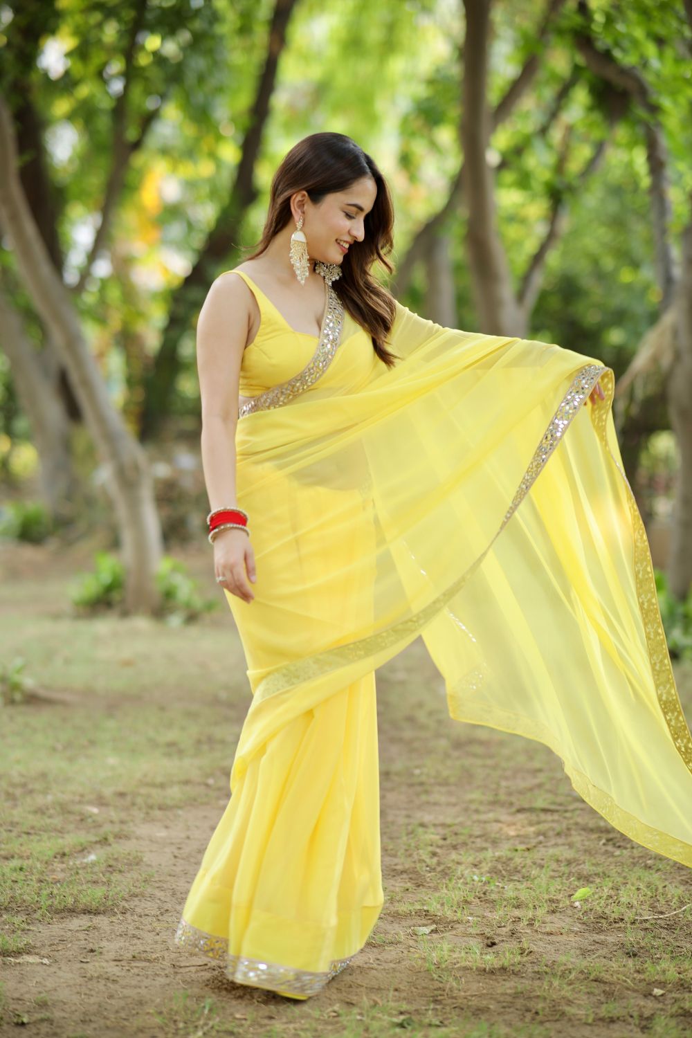 Yellow georgette saree with matching blouse from Imagine By Shiwali, showcasing intricate drape and vibrant color.