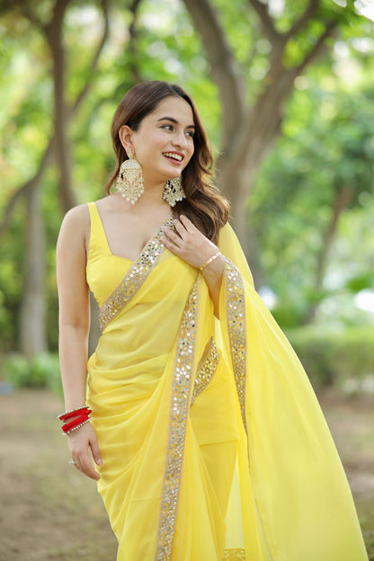 Yellow Raveena Georgette saree with matching blouse from Imagine By Shiwali, featuring elegant drape and intricate designs.