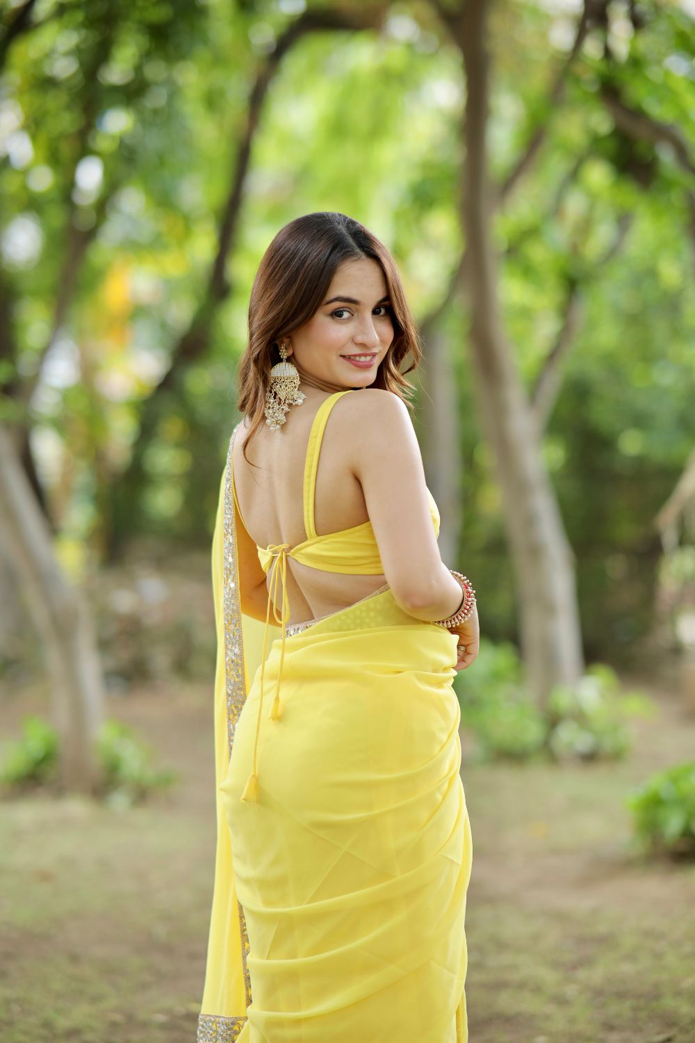 Yellow georgette saree with matching blouse from Imagine By Shiwali, featuring elegant drape and vibrant color.