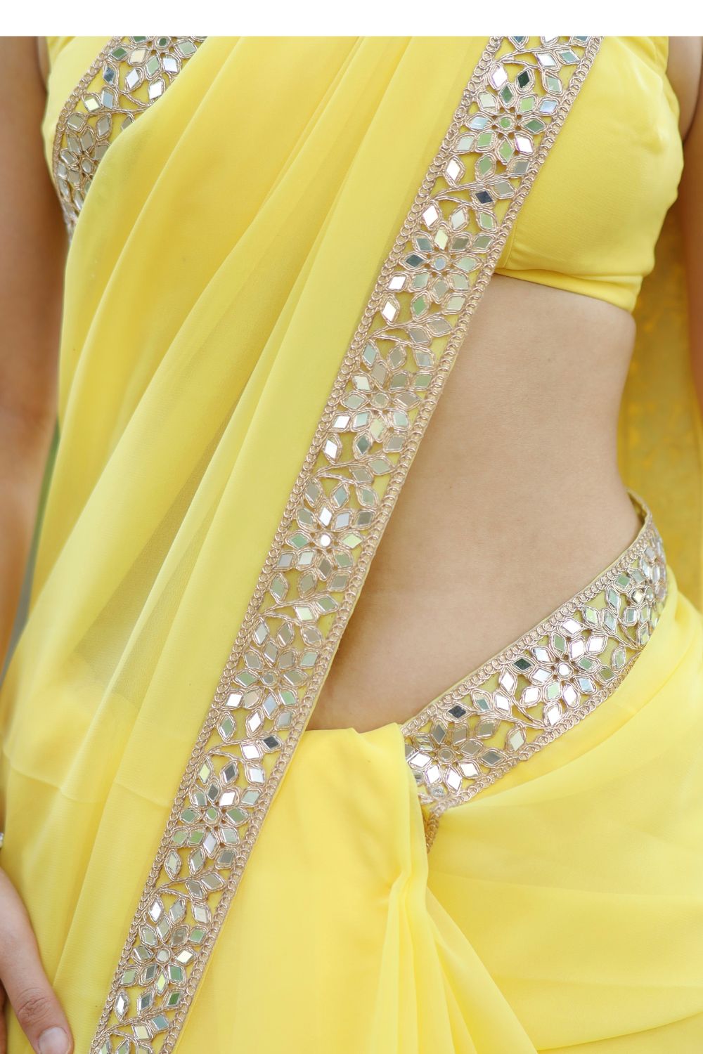 Yellow Raveena Georgette saree with matching blouse, traditional Indian attire by Imagine By Shiwali, displayed with intricate draping.