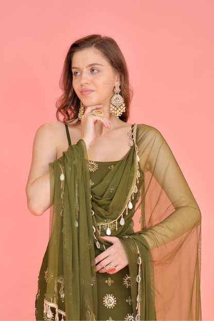 Green Rekha Sharara Suit by Imagine By Shiwali featuring a flowy sharara and matching top with intricate embroidery.