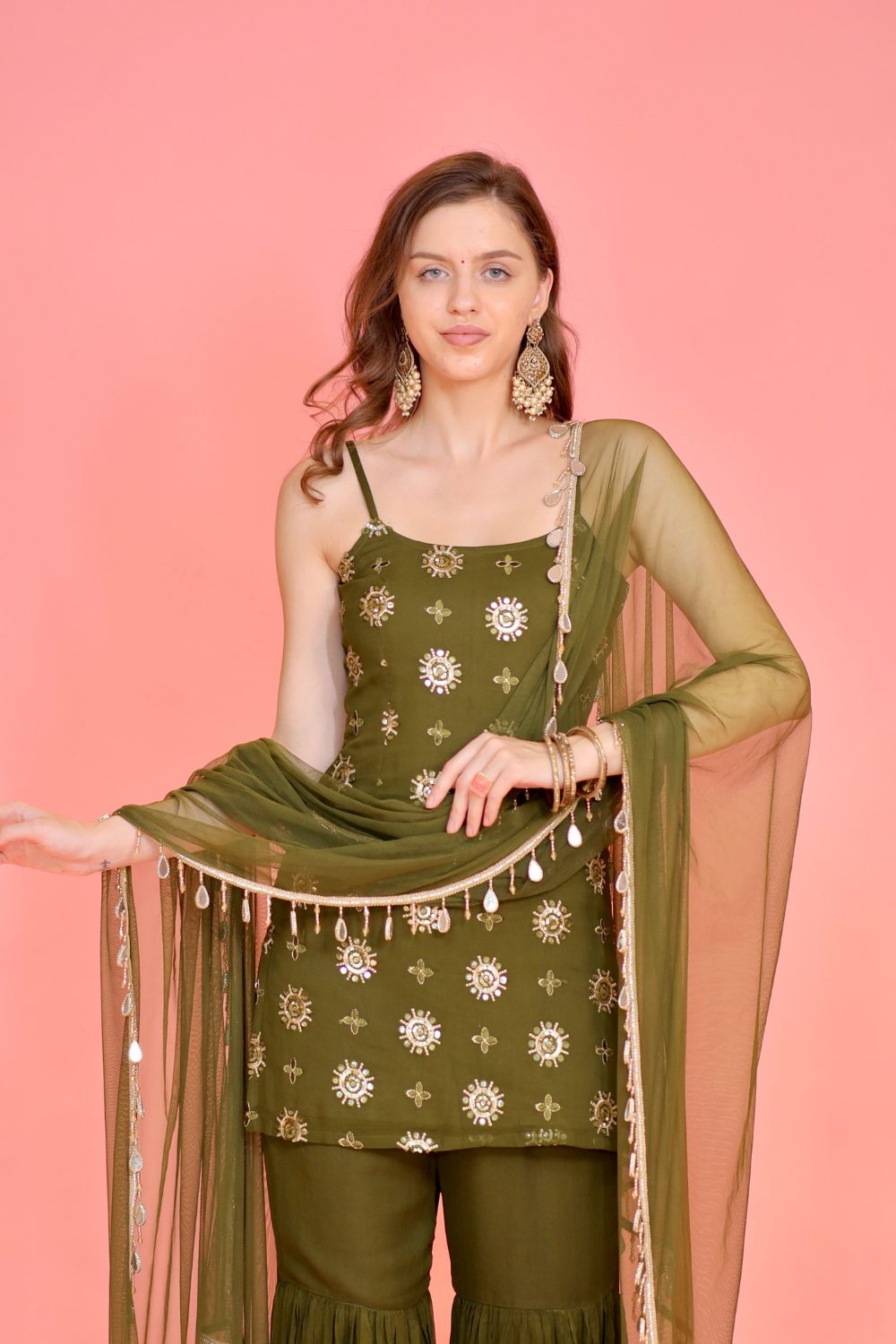 Rekha green sharara suit by Imagine By Shiwali featuring intricate embroidery and traditional style, displayed on a hanger.