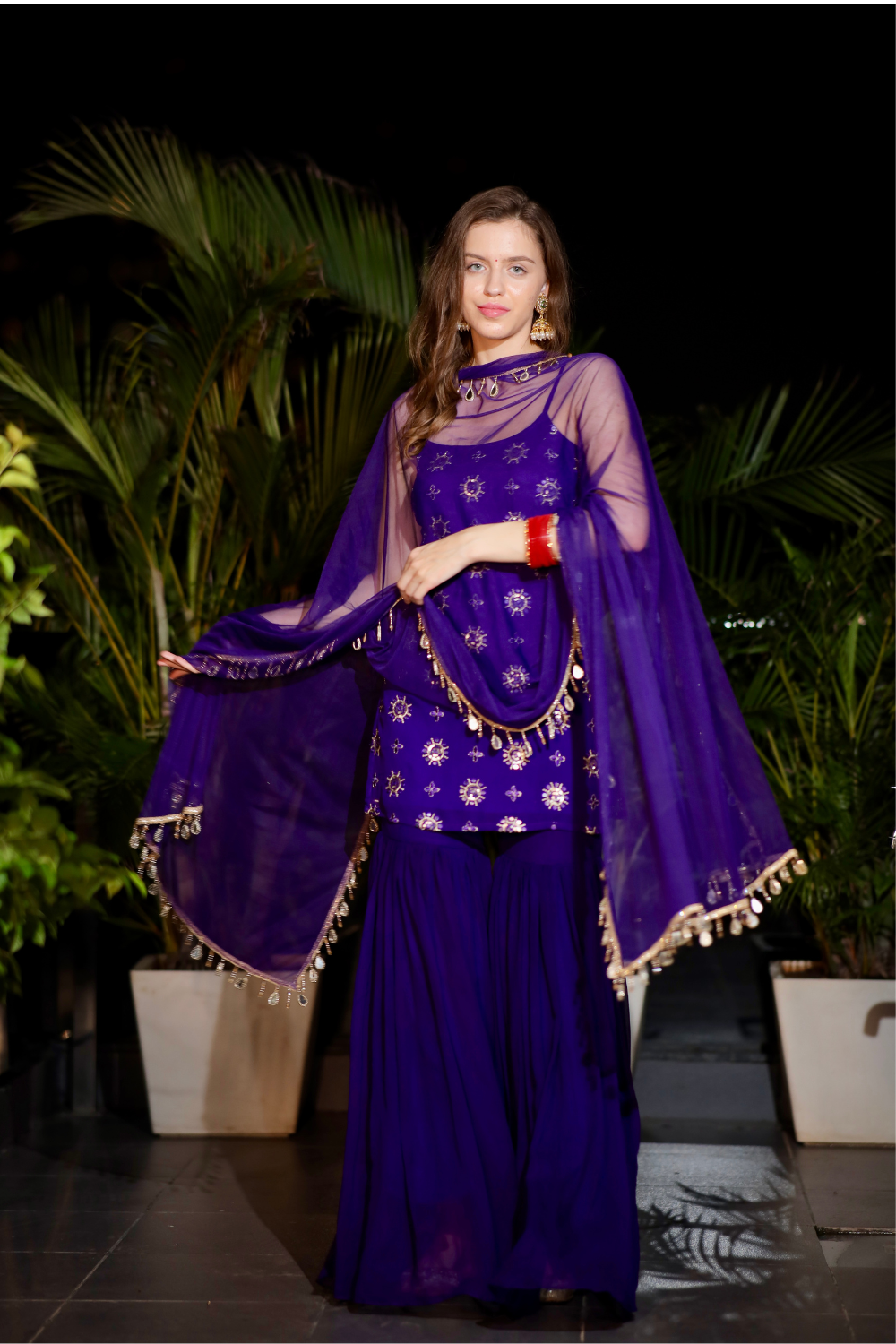 Purple Rekha Sharara Suit by Imagine By Shiwali featuring intricate embroidery and flowing fabric, perfect for traditional occasions.